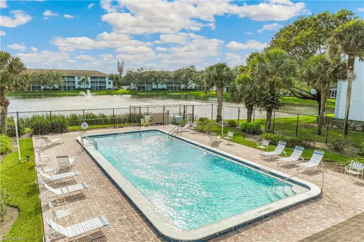 View of swimming pool with a patio area and a water view