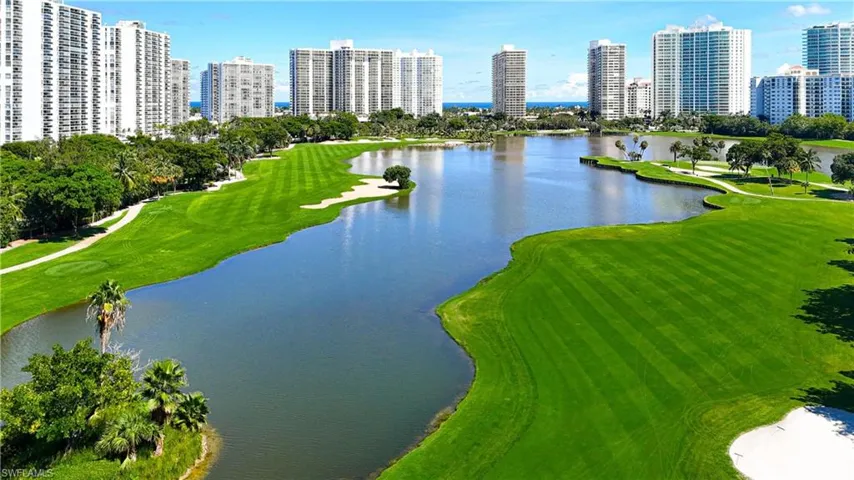 Birds eye view of property featuring a water view, golf course view, and a view of city