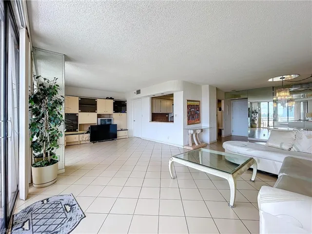 Living area featuring visible vents and a textured ceiling
