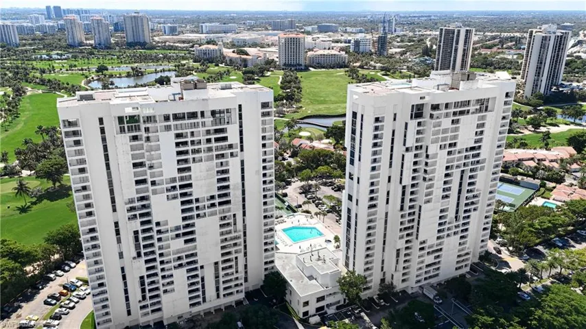 Birds eye view of property with view of golf course and a water view