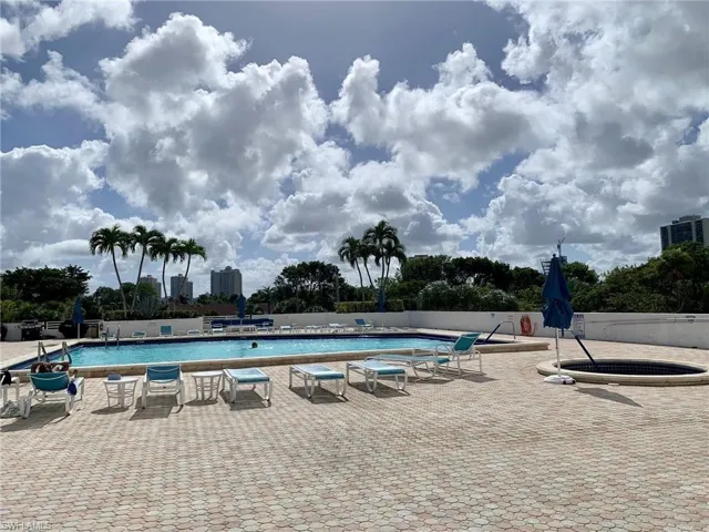 Community pool with a patio