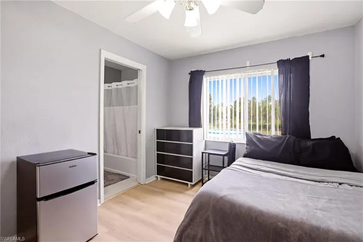 Room with light wood-finish flooring and light wall paint