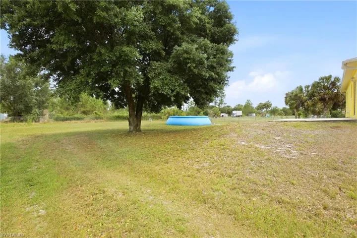 Expansive yard featuring mature trees.
