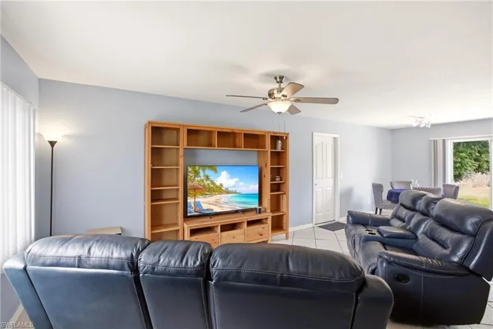 Open concept living area featuring light blue walls and a ceiling fan