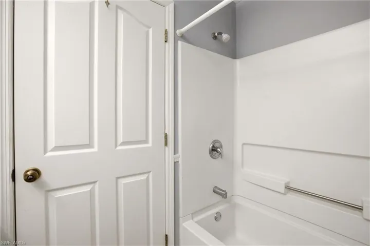 Bathtub and shower combination featuring an integrated shower surround