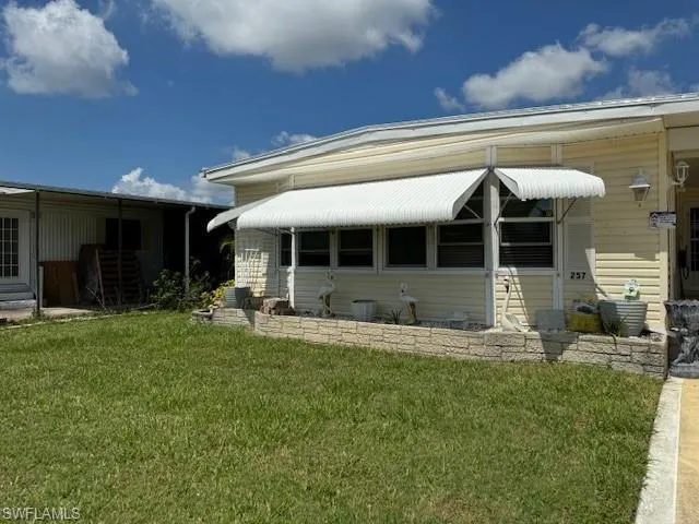 Rear view of property featuring a lawn