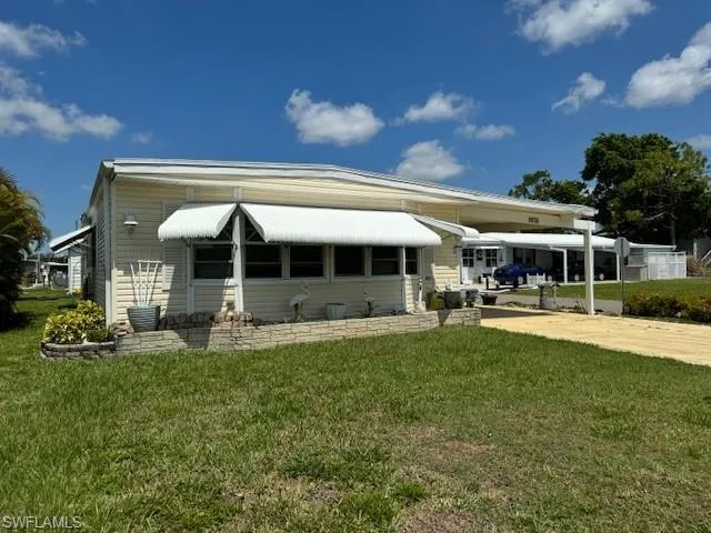 Rear view of property featuring a lawn