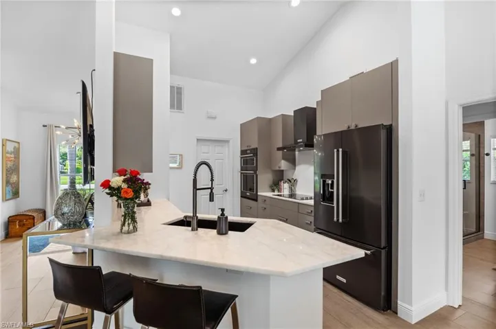 Eat-in kitchen with plenty of storage featuring African white marble countertops and upgraded cabinetry