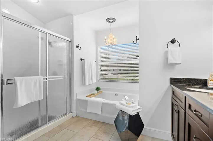 Master bathroom featuring walk in shower and bathtub