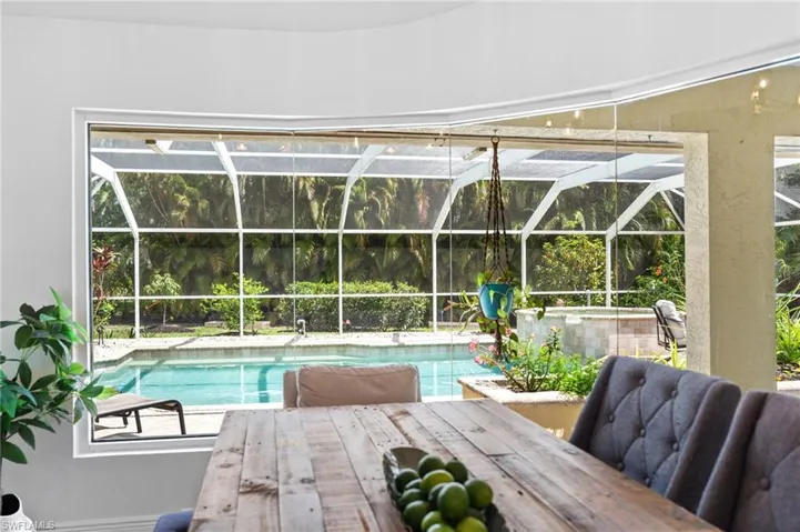 Relaxing view of the private pool and spa from the dining room through the oversized windows