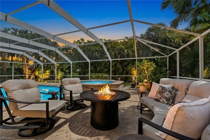 Private screened in lanai and patio with 38 ft long heated pool and spa, plenty of space to relax or entertain and firepit