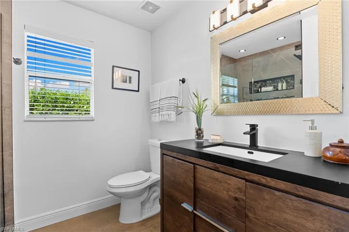 Secondary bathroom with single vanity and window