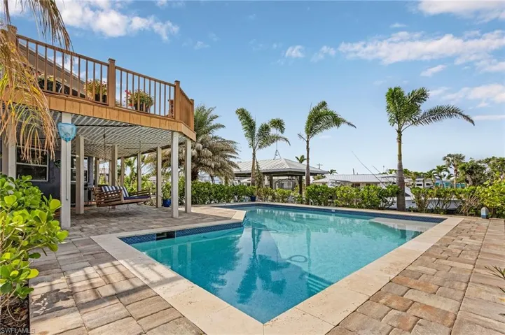 The cherry on top of this must see home is the outdoor oasis created by the multiple seating areas, heated SALT WATER POOL and there is even a sandy beach complete with a hammock to relax the day away!