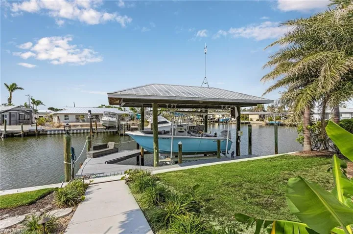 A boat lift and dock awaits on the canal to spend lazy days on the water and exploring the local area.