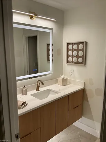 Bathroom featuring vanity and light tile patterned floors