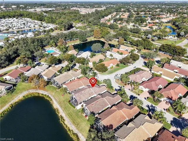 Aerial overview of property's location featuring a large body of water and nearby suburban area