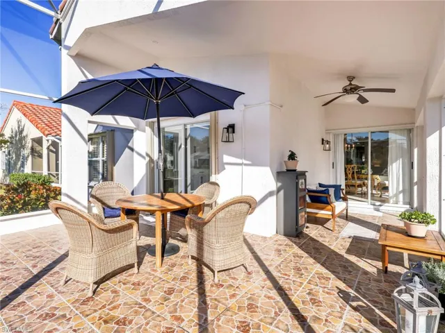 View of patio / terrace with a ceiling fan, a sunroom, a lanai, and outdoor dining area