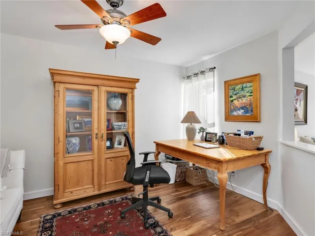 Office area featuring wood finished floors and ceiling fan