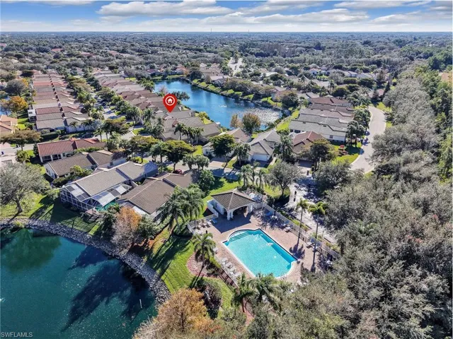 Aerial view of property's location featuring a large body of water and a pool