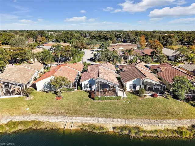Aerial perspective of suburban area with a nearby body of water