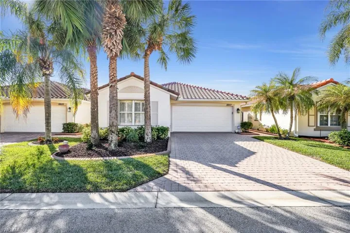 Mediterranean / spanish-style home featuring an attached garage, decorative driveway, stucco siding, and a front yard