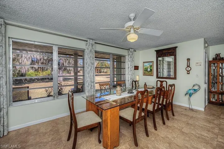 Dining space with a textured ceiling and ceiling fan
