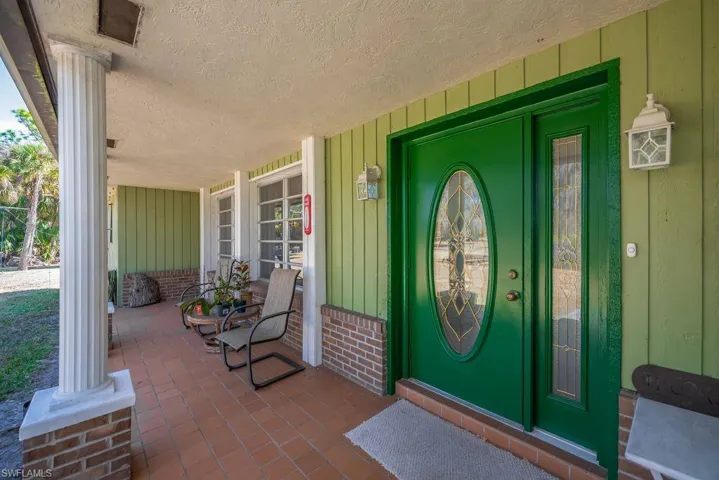 Doorway to home with covered porch