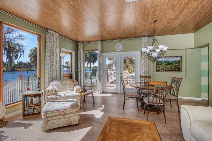Sunny Great Room with a chandelier, french doors, and a river view