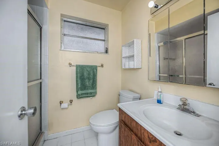 Bathroom 3 featuring a shower with door, vanity