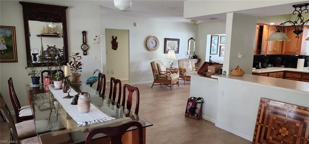 Dining area with baseboards and a textured ceiling