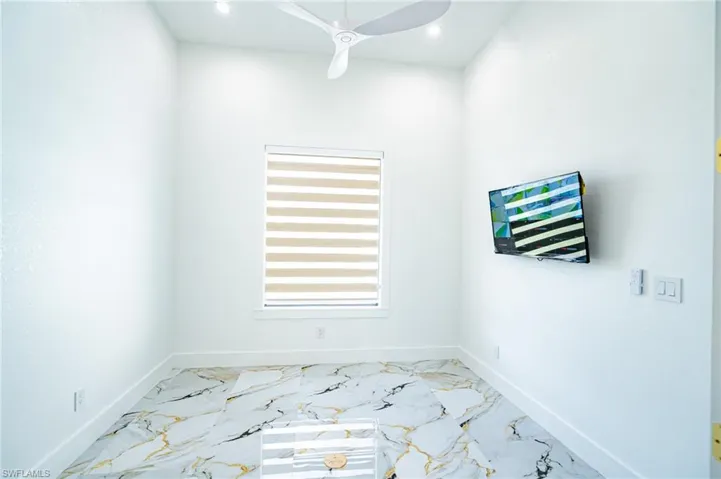 Recessed lighting, ceiling fan, window with horizontal blinds, and a tile floor