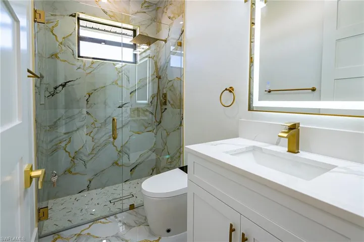 Custom glass shower enclosure with a rain shower head