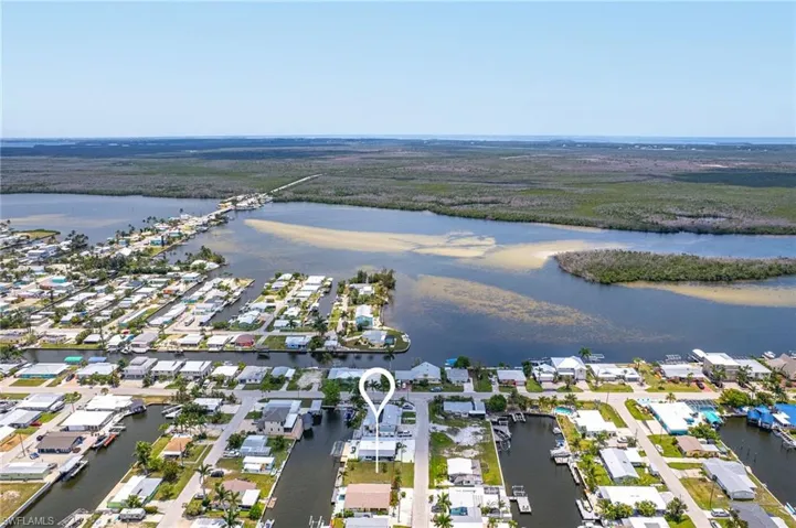 Birds eye view of property with a water view