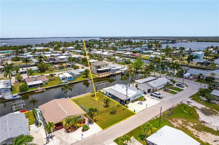 Birds eye view of property with a water view