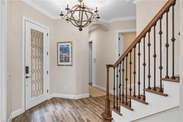 Welcoming foyer with gorgeous open staircase leading to upstairs loft and an additional bedroom/bath.