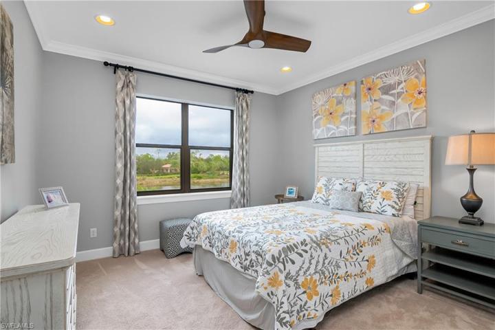 Bedroom 3 is adjacent to the loft and features crown molding and a beautiful lake view.