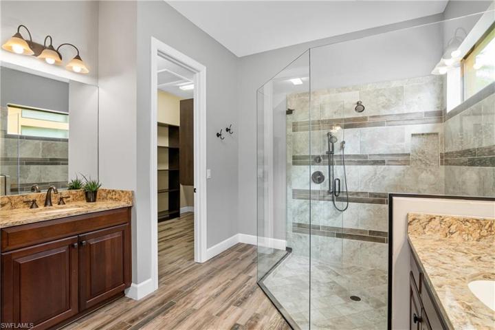 Owner bath with dual sinks and custom closets.