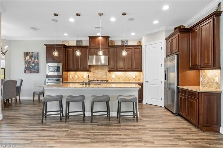 Entertaining is a breeze in this GORGEOUS kitchen featuring NATURAL GAS appliances, oversize island, walk-in pantry and plenty of cabinet space!