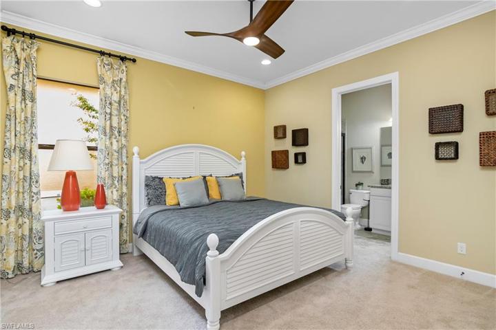Your guests will love this first floor guest bedroom, which includes crown molding, designer ceiling fan, a large closet, and an ensuite bath.