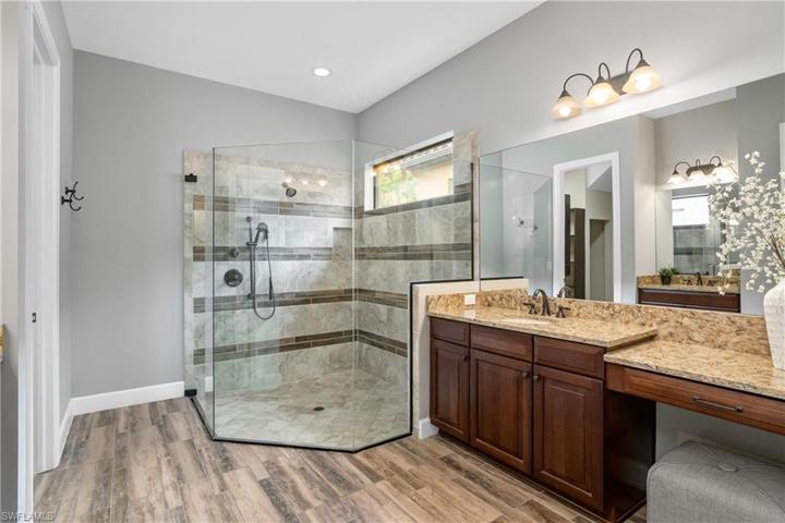 Owner bath includes a large walk-in shower and dual sinks.
