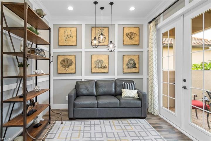 Custom designed den is located at entryway and includes exterior french doors to outdoor courtyard.