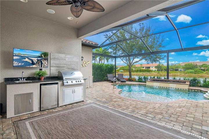 Enjoy indoor/outdoor living on your covered lanai featuring an outdoor kitchen, pool bath, and custom pool and spa.