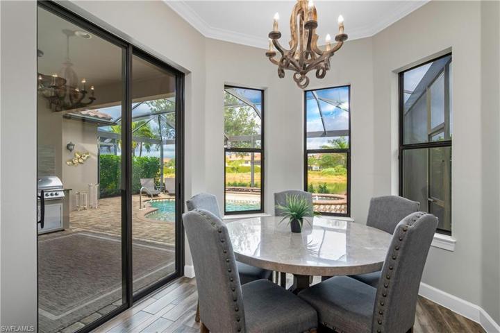 Kitchen cafe features designer lighting, sliding door entry, and beautiful water views.
