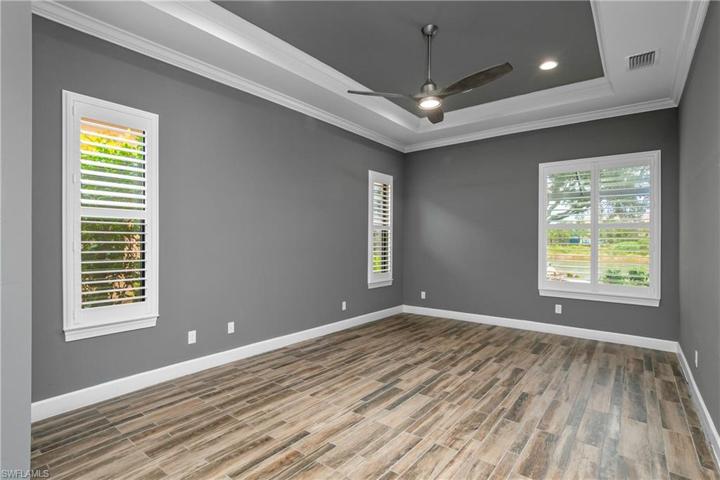Owner suite is large and spacious and features a beautiful tray ceiling with crown molding and plantation shutters.