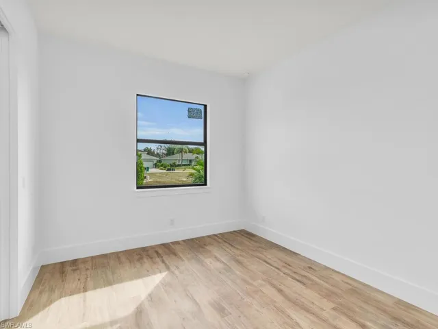 Empty room with light wood finished floors and baseboards