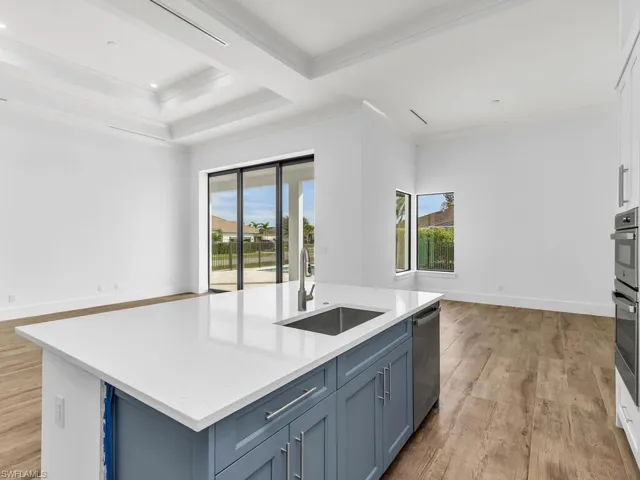 Kitchen featuring a wealth of natural light, a sink, light wood-style floors, and dishwasher