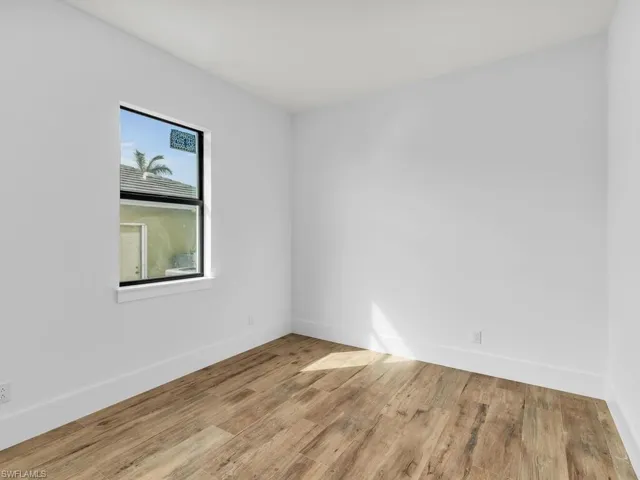 Empty room featuring baseboards and wood finished floors