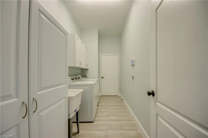 Washer, Dryer, a stand up cabinet for pool towels, cleaning supplies
