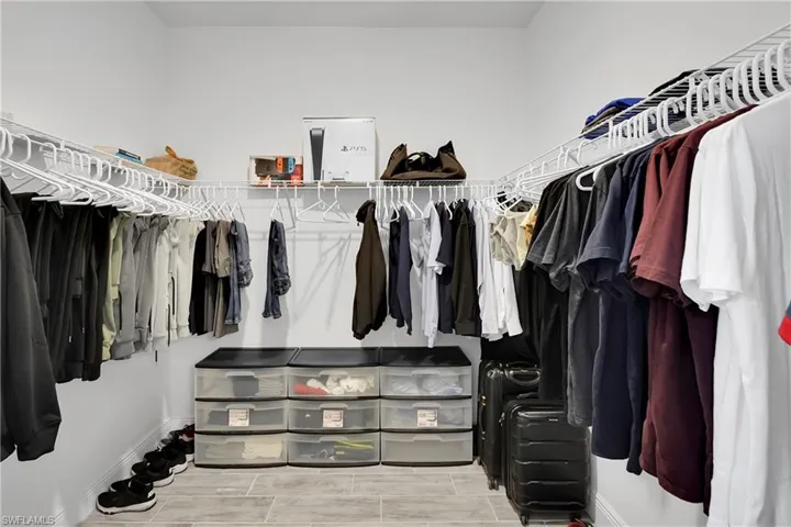 Spacious closet with wood tiled floors