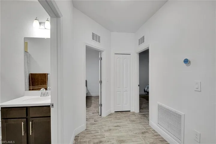 Bathroom featuring vanity and wood tiled floors